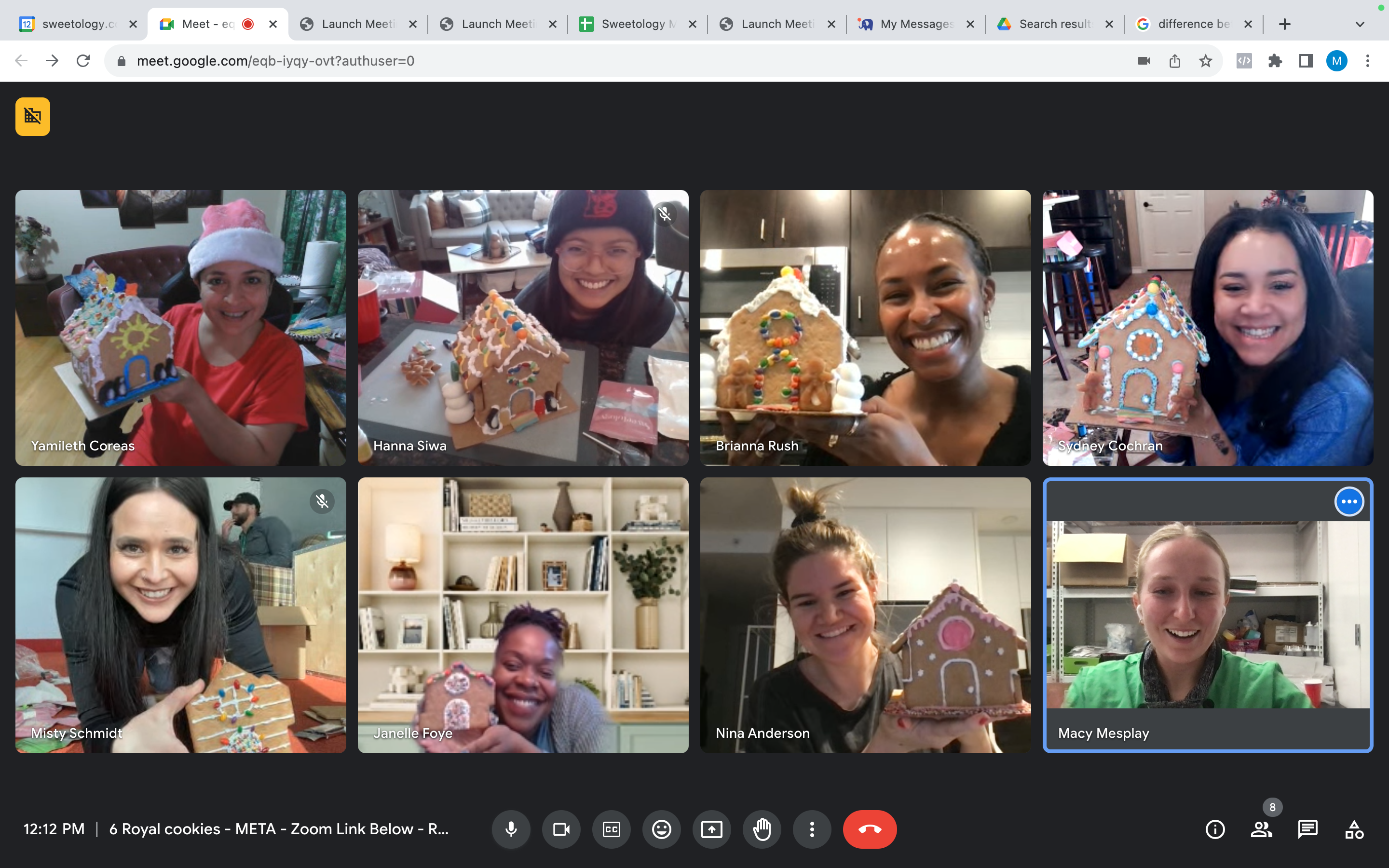 Virtual corporate team members showing off their decorated gingerbread houses on a video call
