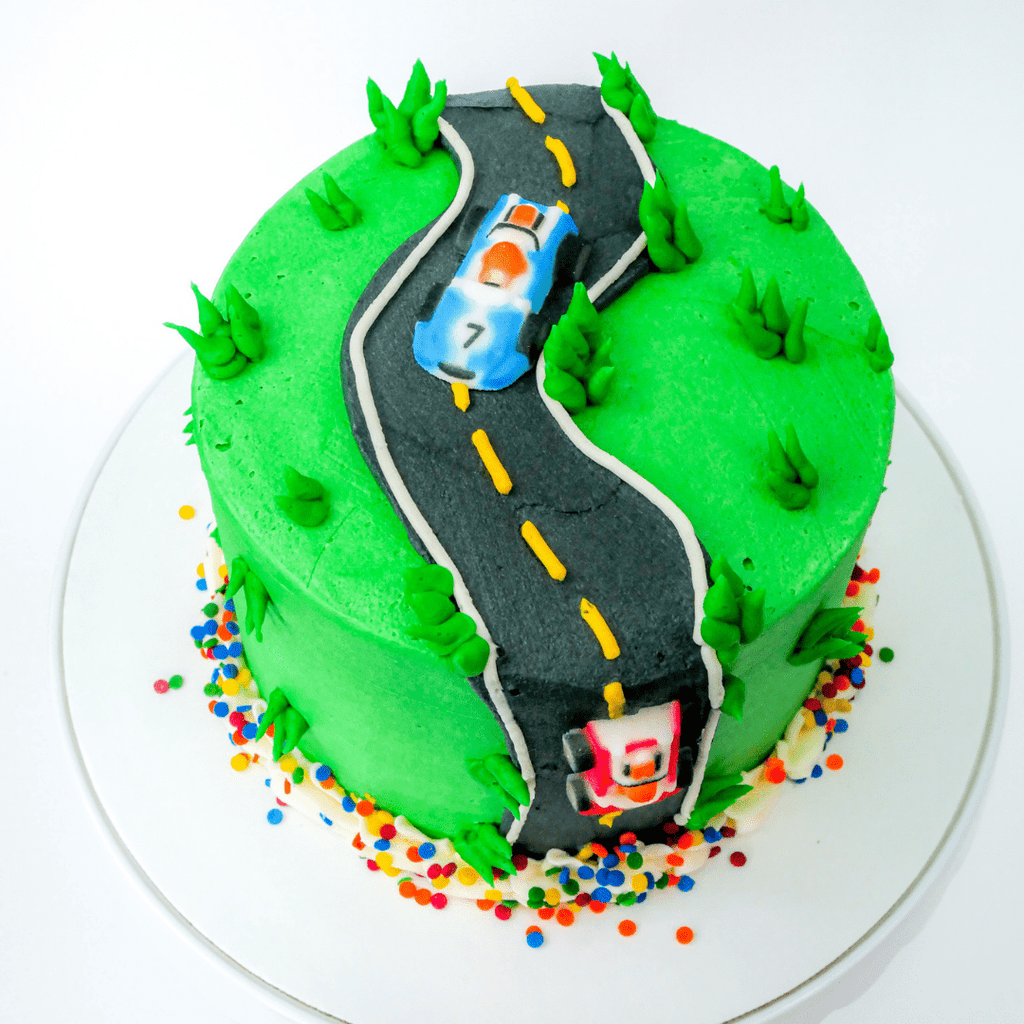 The Race Track cake decorating kit comes with your choice of cake along with homemade buttercream and instructions to create a beautiful work of edible track that is sure to rev the engine of the racecar lover in your life